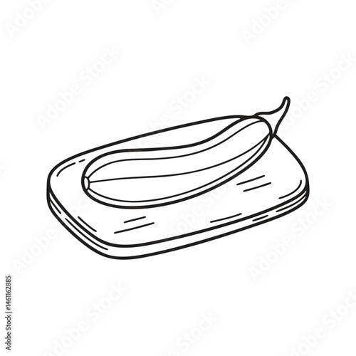 A snake gourd resting on a chopping board