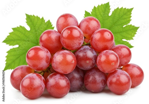 Close up of a bunch of red grapes with green leaves on a white background