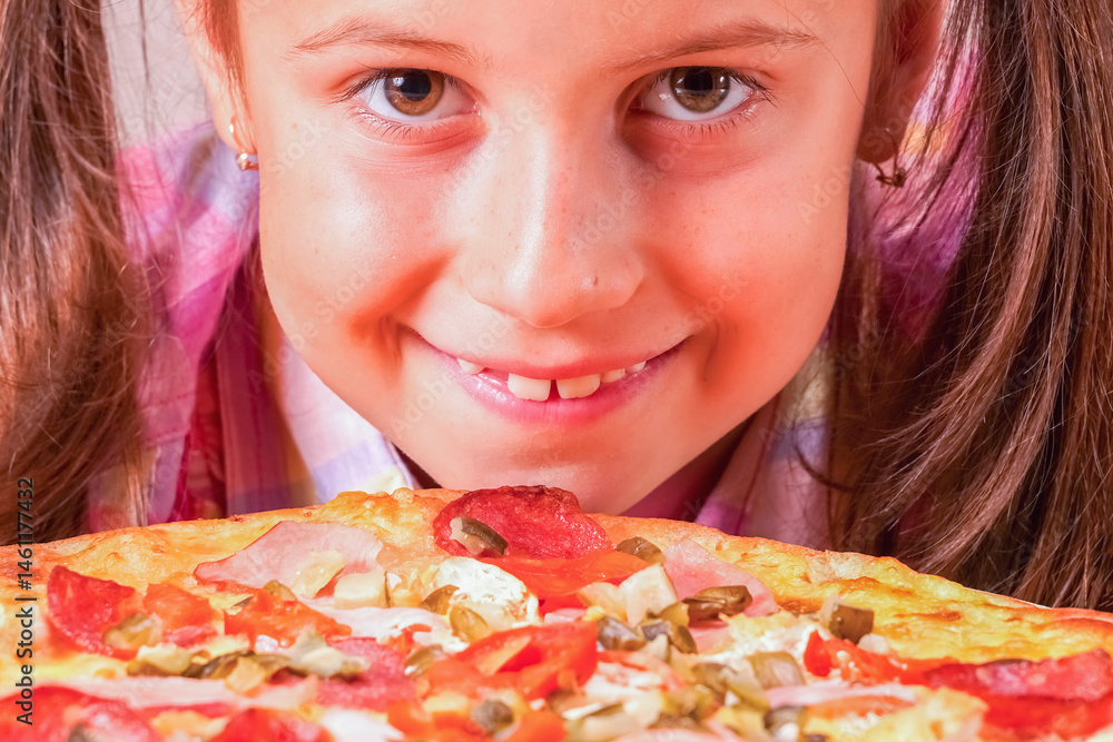 Portrait of happy young girl with pizza. Horizontal image.