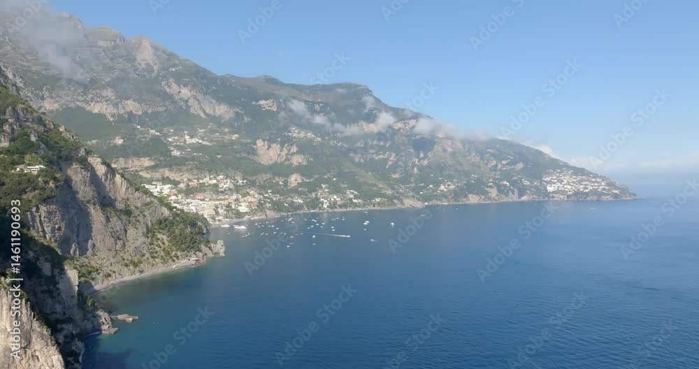 Panoramic aerial view of the Amalfi Coast, in the province of Salerno, Campania, Italy. In the center of the panorama there is the town of Positano, one of the most touristic and beutiful destinations Panoramic aerial view of the Amalfi Coast, in the province of Salerno, Campania, Italy. In the center of the panorama there is the town of Positano, one of the most touristic and beutiful destinations
