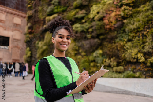 Volunteer engaging in activism by collecting signatures outdoors