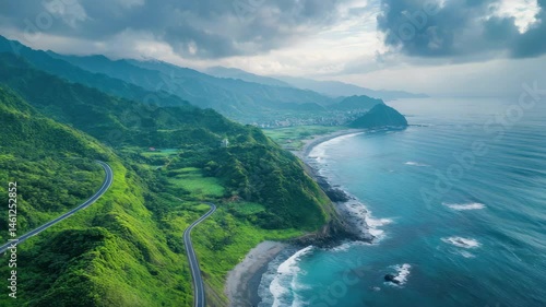 Wallpaper Mural Beautiful mountain range with a long road that leads to the ocean. The road is surrounded by lush green trees and the ocean is calm and blue. The scene is peaceful and serene, with the mountains Torontodigital.ca