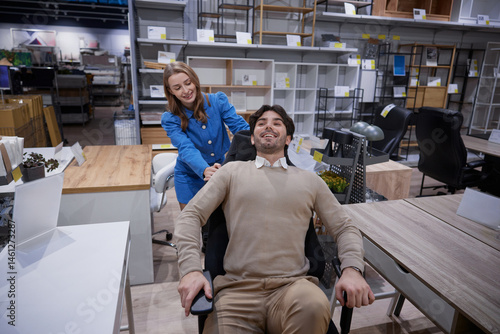 Obraz na płótnie Two people relax in stylish office furniture showroom showcasing modern designs w salonie