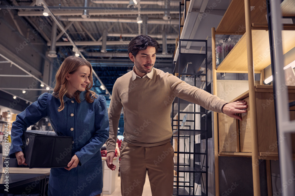 A couple is happily exploring a furniture store together, enjoying the experience and atmosphere