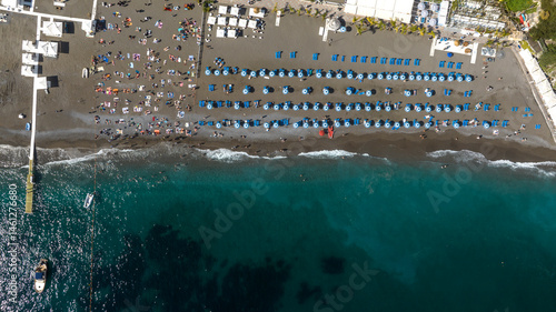 Obraz na płótnie Perpendicular aerial view of the beach of Positano in the province of Salerno, Campania, Italy. There are umbrellas on the sand and people on vacation at sea. w salonie