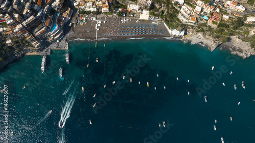 Obraz na płótnie Perpendicular aerial view of the beach of Positano in the province of Salerno, Campania, Italy. There are umbrellas on the sand and people on vacation at sea. w salonie
