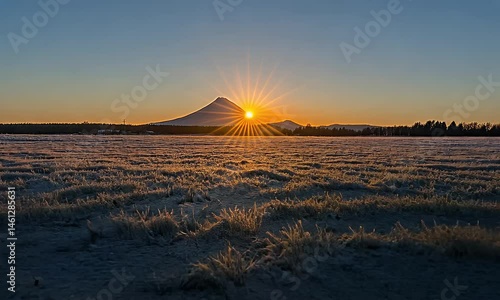 Snowy Mountain Sunrise over a Frosty Field
