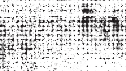 A dense scattering of dark dots forms a blurred textured across a white background.