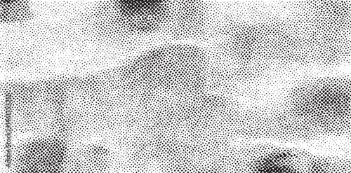 A grayscale displays a blurred textured landscape with subtle tonal variations.