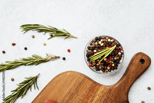 Colorful spices and herbs arranged on a cutting board in a kitchen setting