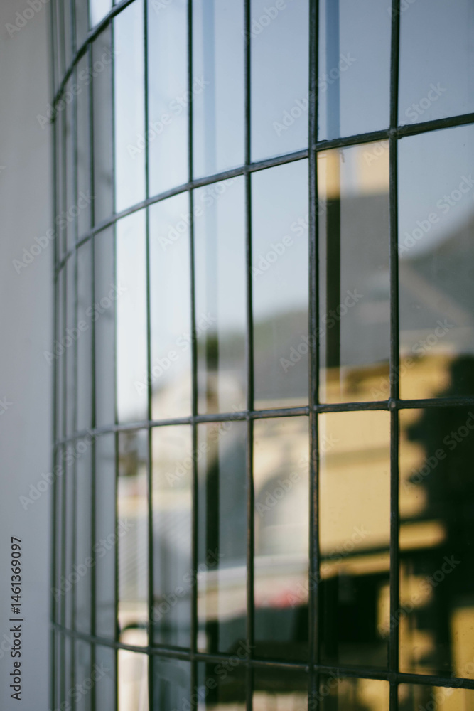 A glare-curving window consisting of small rectangular panes of glass