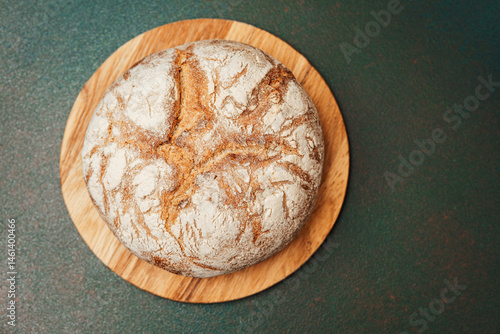 Obraz na płótnie Freshly baked bread on a wooden board ready to be served w salonie