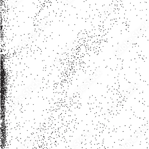A dense scattering of small dark dots covers a textured white surface.