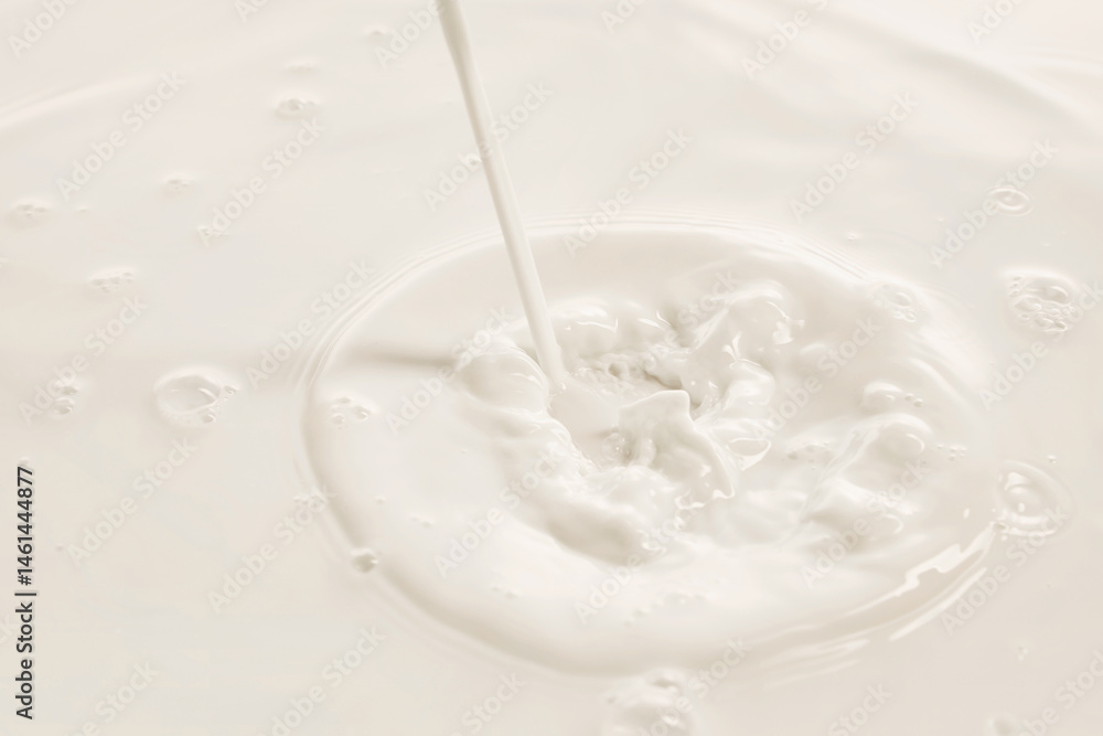 Milk stream hits white liquid creating splash and swirl in soft lighting. Concept of drink, organic food, aesthetics, advertisement