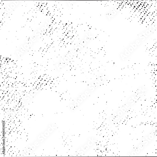 A scattered textured white surface exhibits a random distribution of small dark dots.