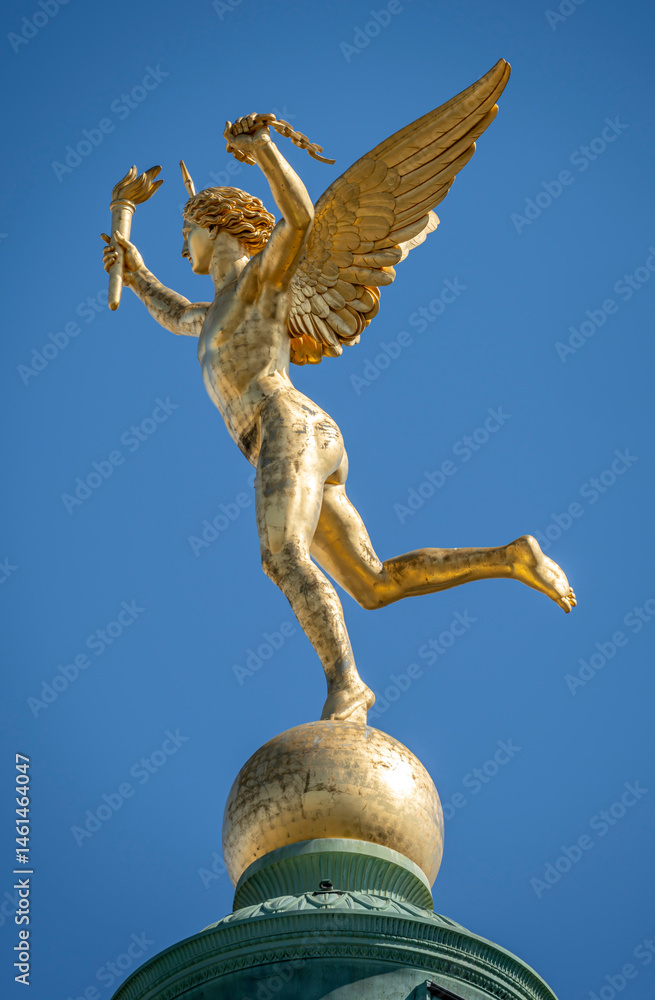 Fototapeta premium Paris, France - 05 03 2025: Place de la Bastille. Detail View of the genius of Liberty golden statue on July column.