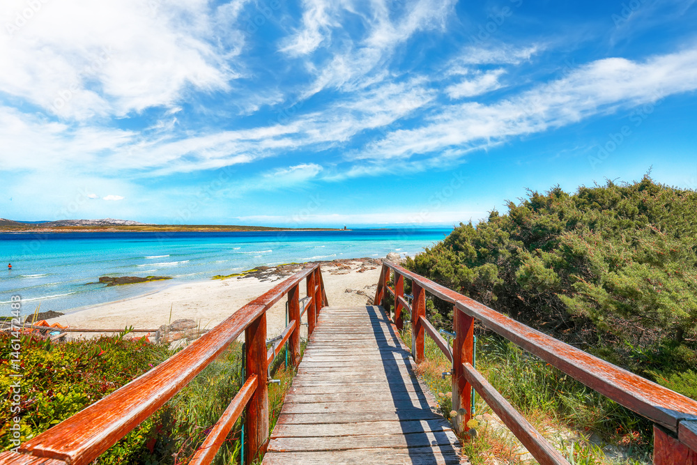 Unbelivable view of Famous La Pelosa beach (Spiaggia della Pelosa) with wooden footbridge.