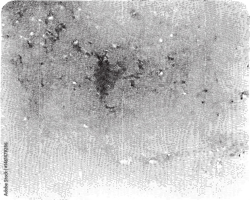 A grainy monochrome depicts a dense cluster of small dark spots against a textured background.
