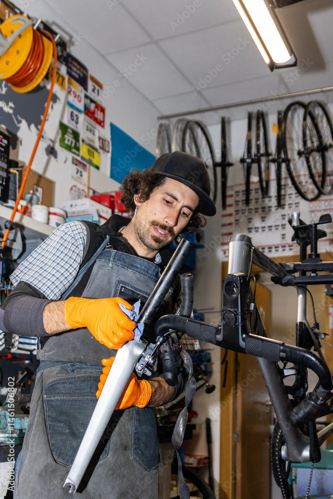 Bicycle mechanic repairing and cleaning modern bike in workshop Bicycle mechanic repairing and cleaning modern bike in workshop