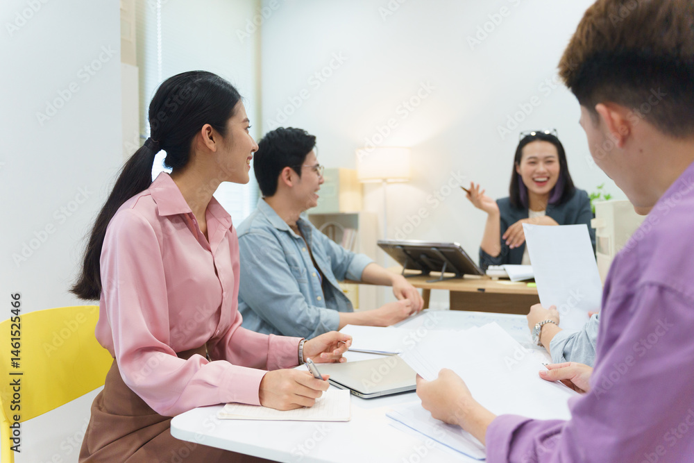 Group of young professionals engaging in a collaborative discussion during a meeting in a modern office environment Group of young professionals engaging in a collaborative discussion during a meeting in a modern office environment