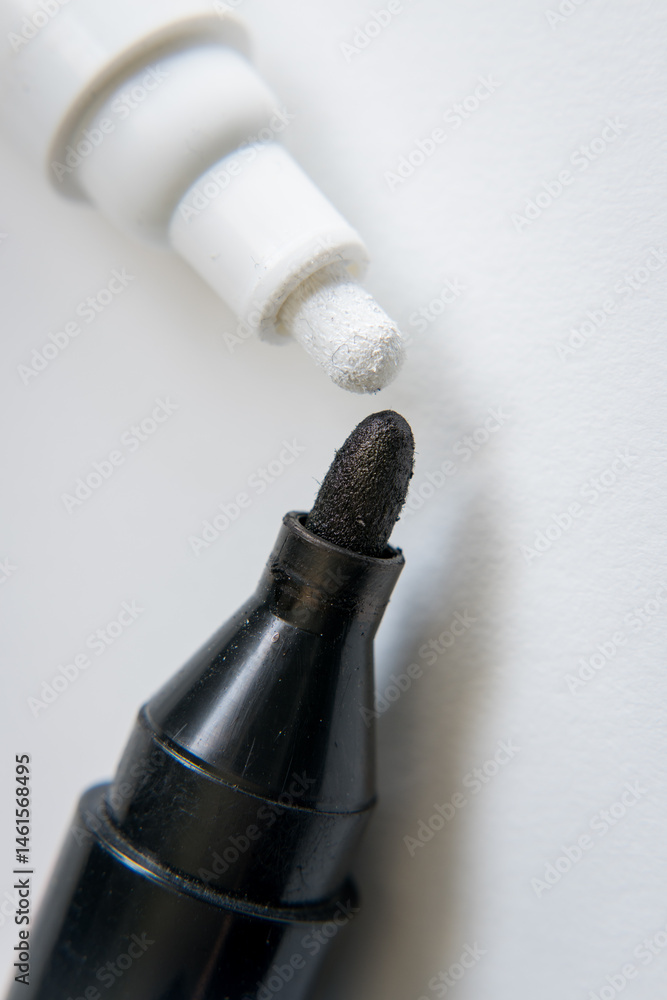 Two markers, black and white.