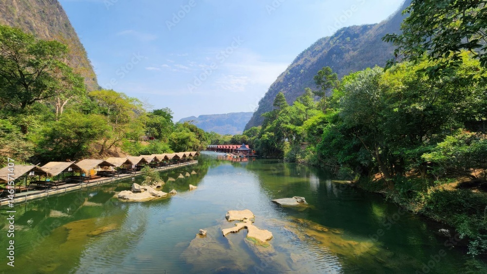 Fototapeta premium Serene River Landscape Surrounded by Lush Green Mountains in Daylight