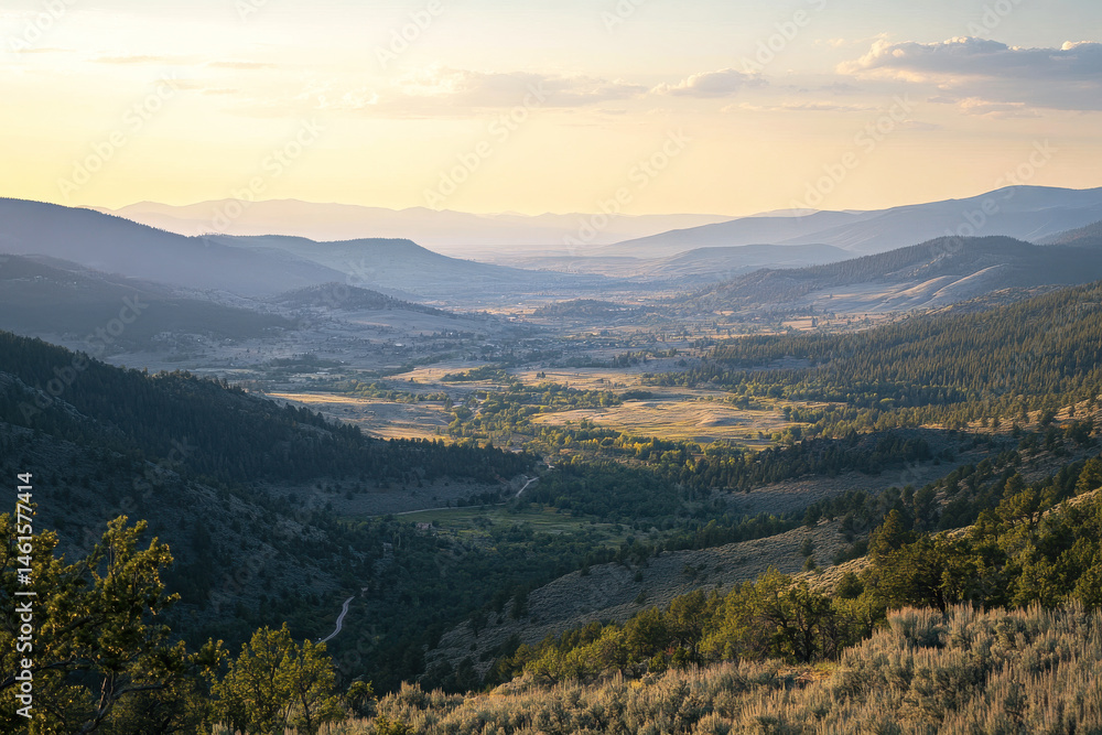 Obraz premium Aerial view of a mountain valley with trees and fields at sunset or sunrise