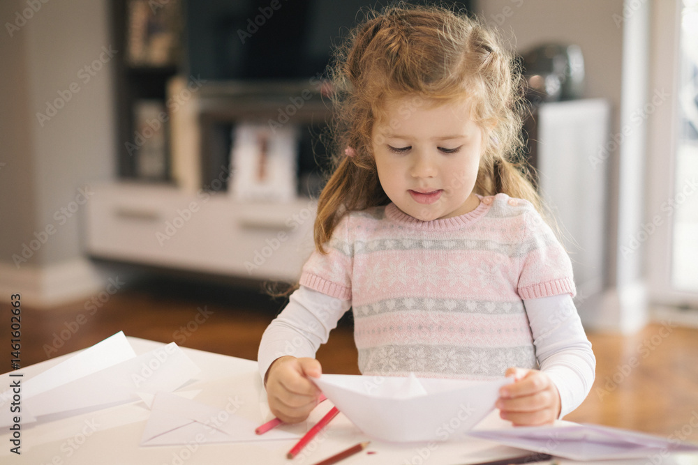 Cute little girl crafting boat from papper Cute little girl crafting boat from papper