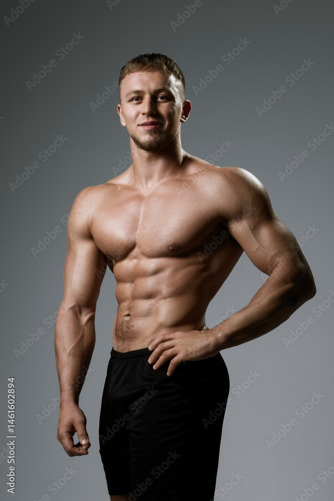 Fototapeta premium A Muscular Male Model captured in a Profile Pose with Dramatic HighContrast Lighting