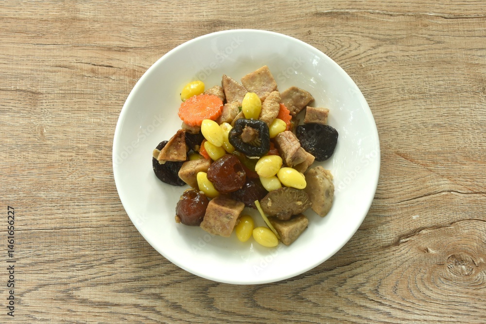 deep fried tofu and gluten with yellow ginkgo and pickled jujube couple black mushroom in soy sauce vegetarian food on plate