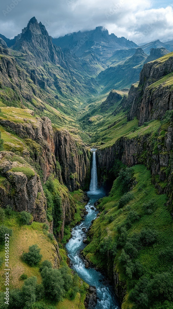 Stunning waterfall cascading through a green valley surrounded by majestic mountains in Iceland Stunning waterfall cascading through a green valley surrounded by majestic mountains in Iceland