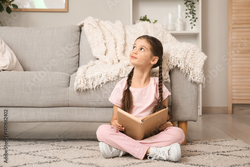 Thoughtful little girl with...