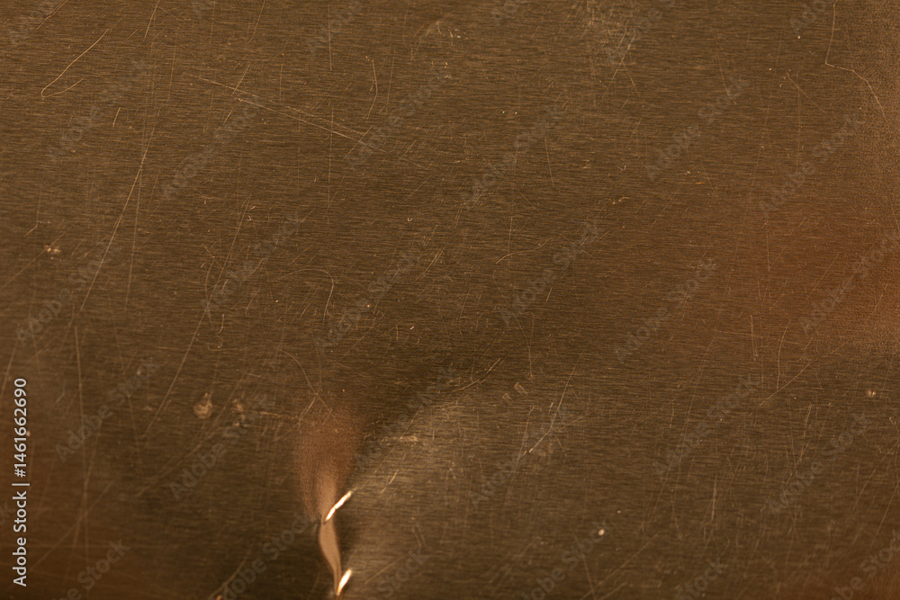 High-resolution image of a scratched gold metal texture. Perfect for backgrounds and design projects.