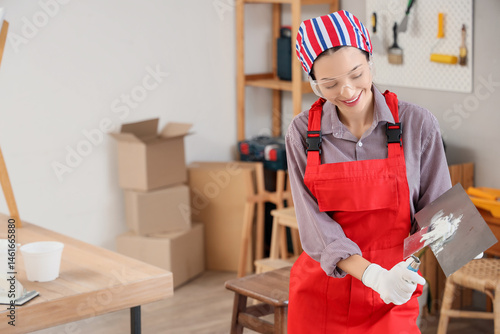 Female decorator with putty...