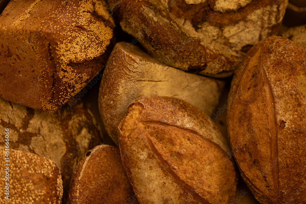 Close-up of various artisan bread loaves, showcasing their crusty textures and golden-brown hues. Perfect for bakery websites or food blogs.