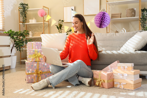 Young woman in party hat wi...