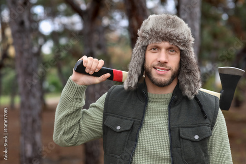 Male lumberjack with axe in...