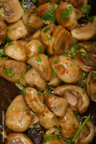 A close-up shot shows sauteed mushrooms glistening with sauce and sprinkled with fresh herb