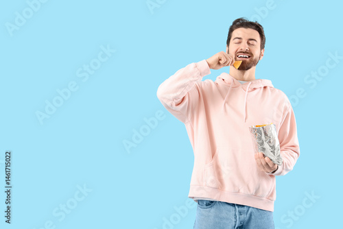 Man eating tasty nachos on ...