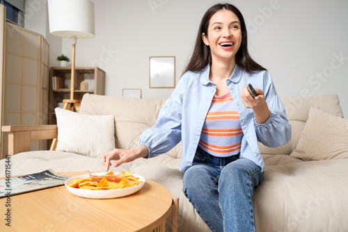 Young girl eating tasty nac...