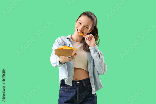 Young girl eating tasty nac...