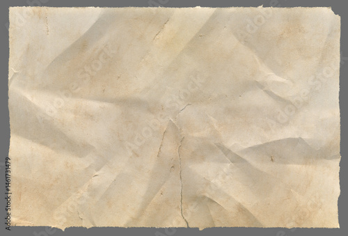 Crumpled sheet of old torn paper with high detail texture of ripped edges carefully isolated on grey background for clipart.