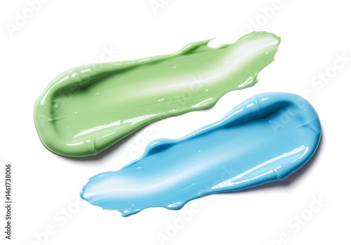 Two smears of cosmetic product in green and blue on a white background in a close up view