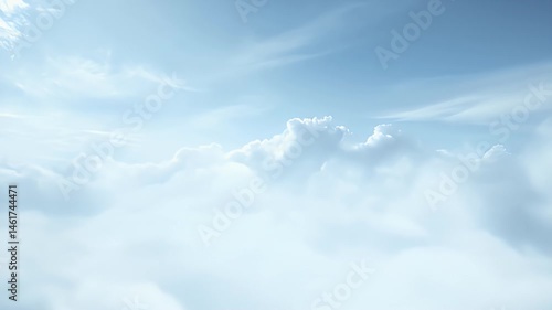 Dramatic Aerial View Of White Puffy Clouds Under A Bright Blue Sky in Sunny Weather