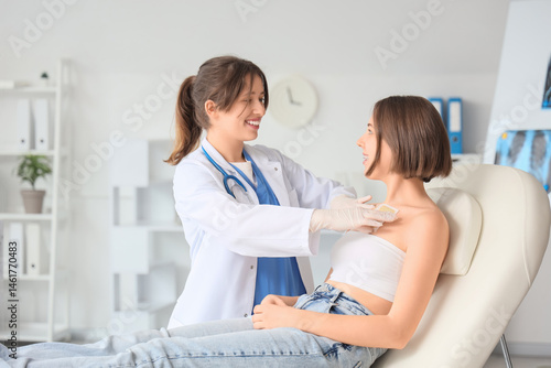 Female doctor applying must...