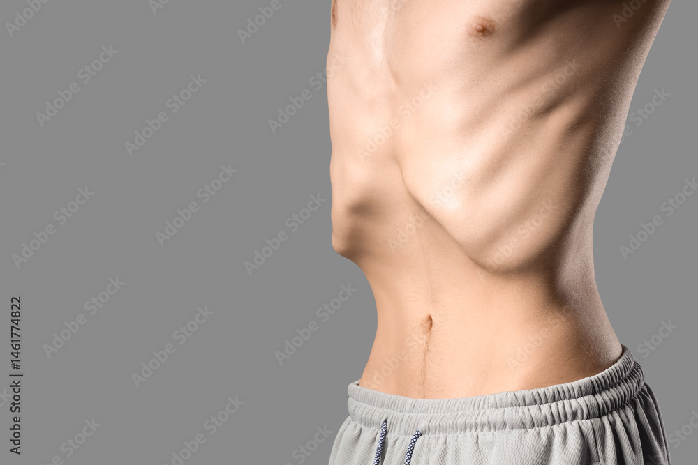 Naklejka premium Young man with anorexia on grey background, closeup