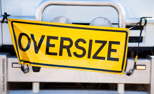 Yellow oversize sign attached to the front on a truck