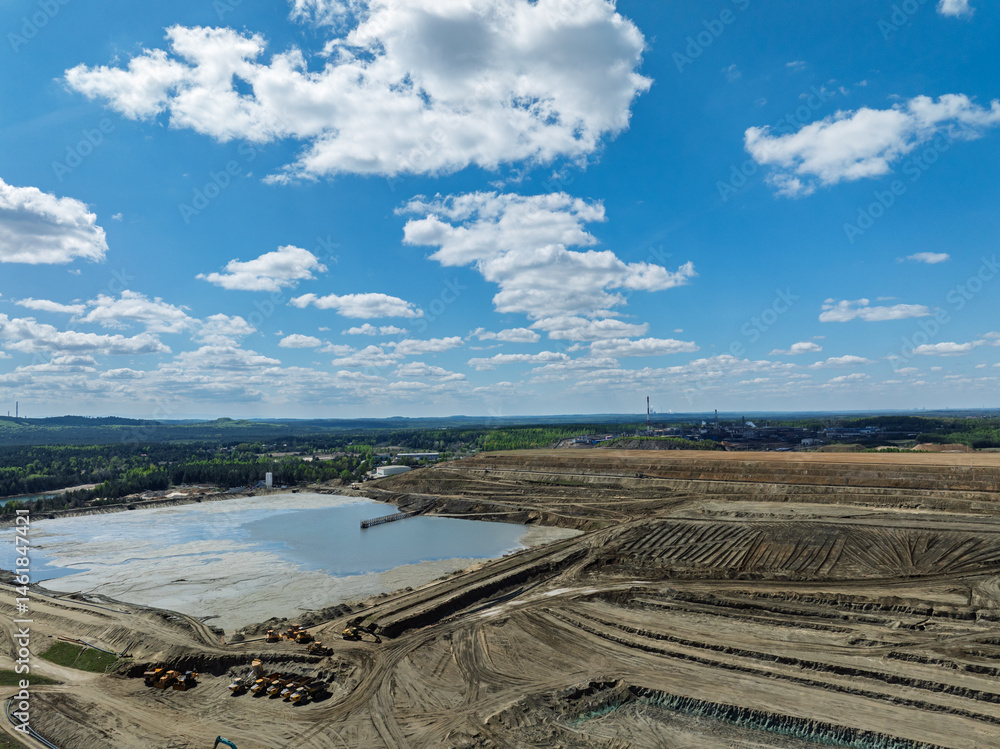 Lake District swallow hole flooded as a result of the mining damage Pomorzany mine in Olkusz,Poland. Aerial drone view of flooded sand pit. Forest submerged in a lake. Sunken sandpit with clear water
