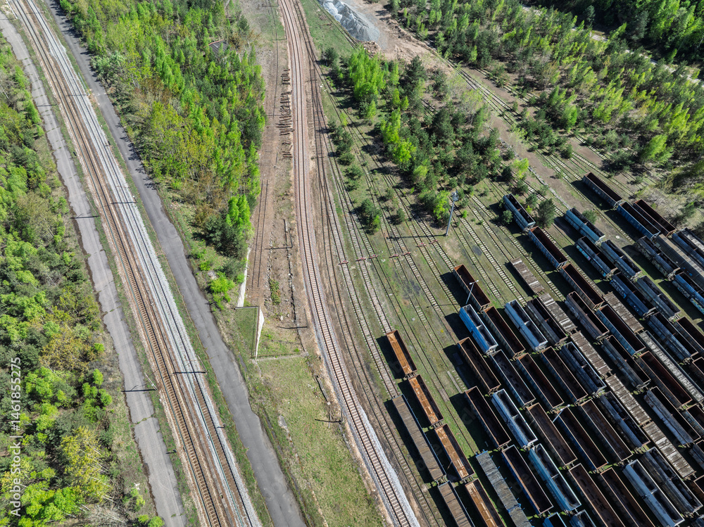 Aerial drone photo of Cargo train terminal, railway hub. Railway wagons on the tracks in industrial area.