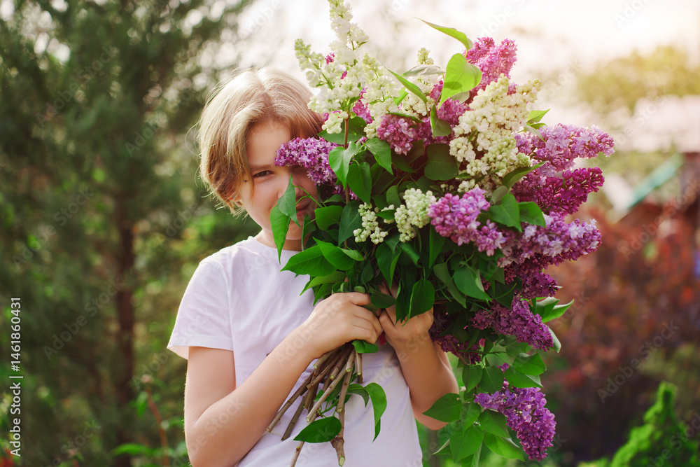 Child holding a large bouquet of colorful lilacs in a garden setting Child holding a large bouquet of colorful lilacs in a garden setting